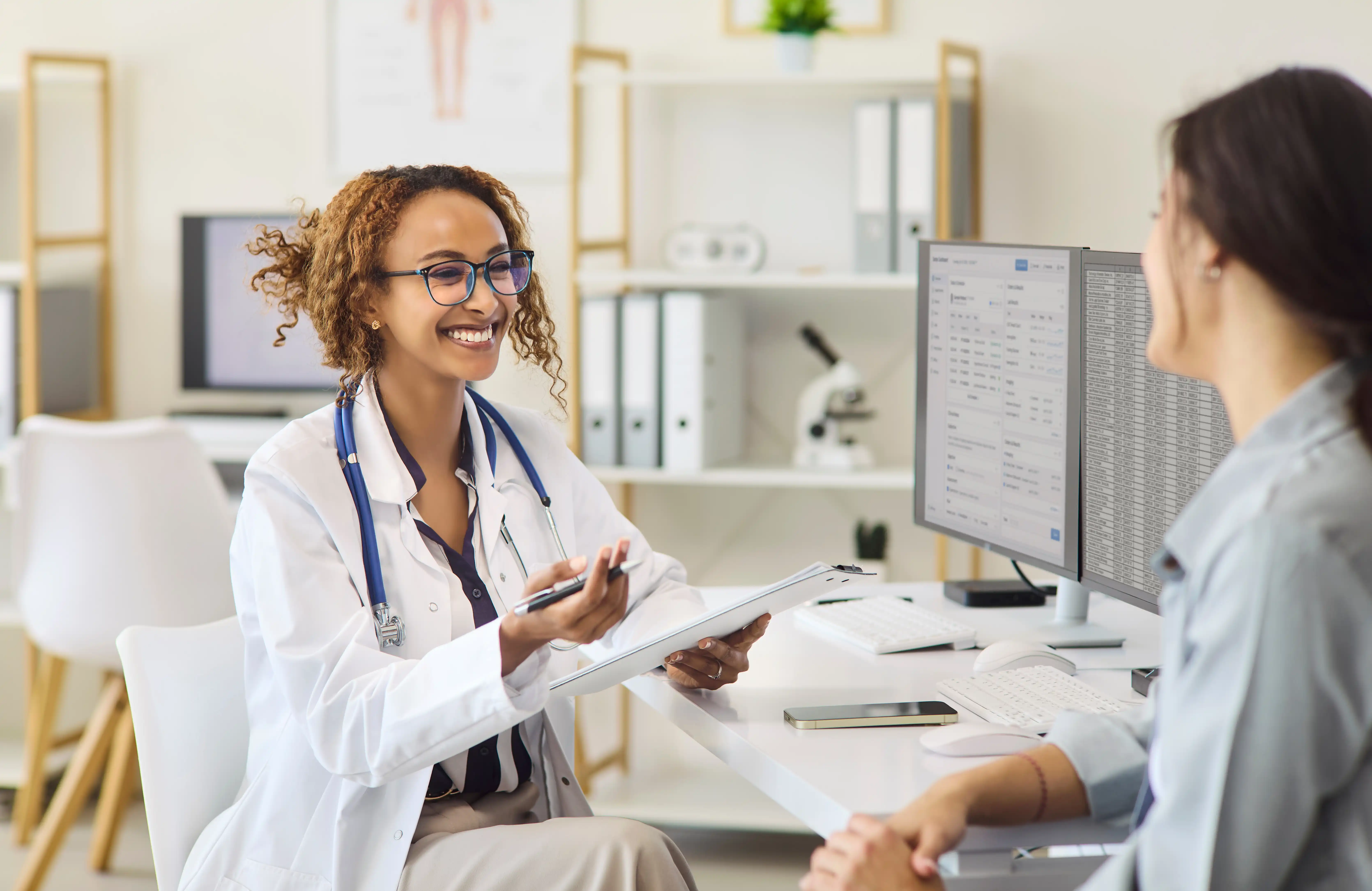 Healthcare operations professionals reviewing critical information in a clinical command environment